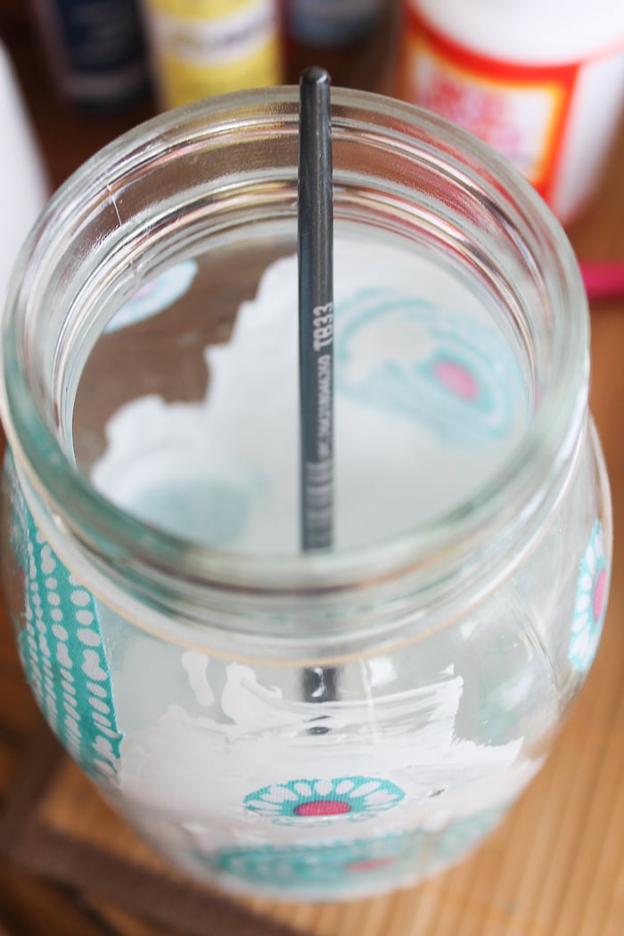 Use a paint brush to paint the inside of your mason jar--I used white paint over my blue and pink floral fabric