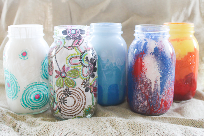 Here are five different ways to paint and decorate mason jars using acrylic paint, fabric, and mod podge