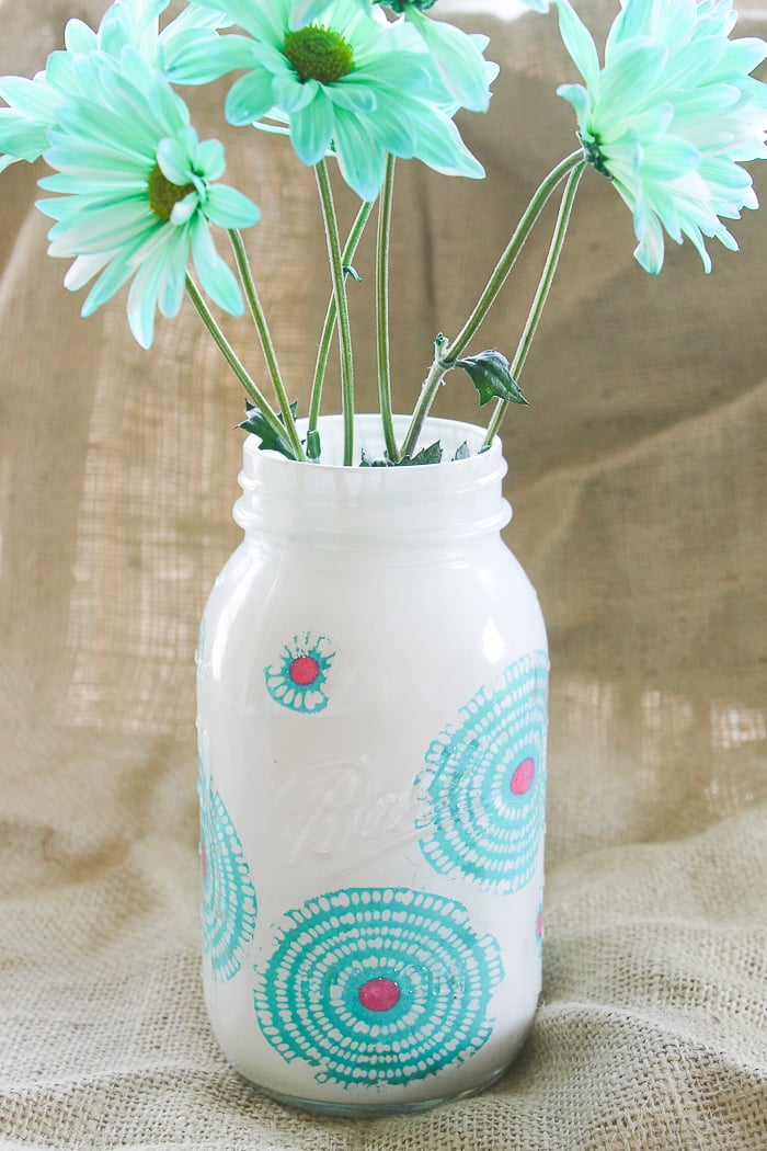 This springy mason jar uses both paint and decoupaged fabric