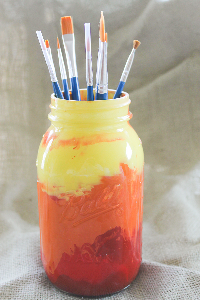 Sunset paint mason jar with red, orange, and yellow paint
