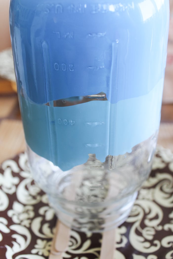 Add a second dollop of lighter blue to the inside of your mason jar, above the darker blue