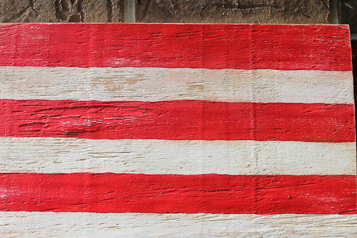 The distressed effect on this Wooden Painted American flag is made with a watered down wood stain