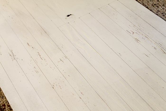 using a ruler to lay out stars and stripes on an the plywood to make an American flag