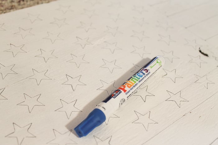 using a paint pen on a stencil will help make perfect stars for your American Flag decor!