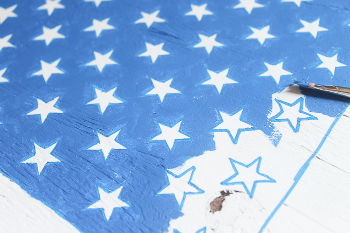 painting stars on a wooden american flag