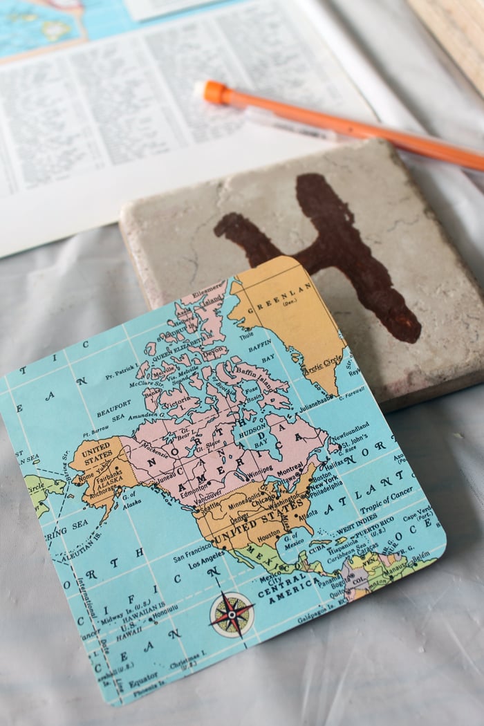 map cutout and tile coaster in background