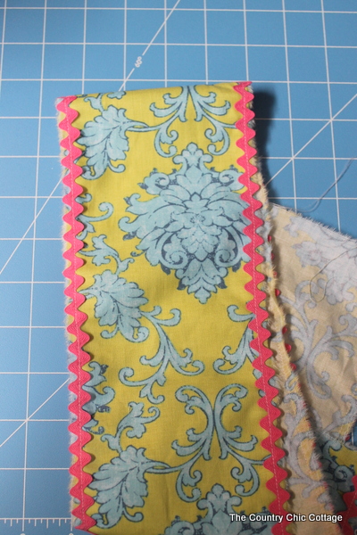 sewing ric rack to side of yellow damask fabric