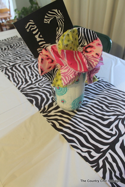 12 card in a centerpiece on a zebra tablerunner