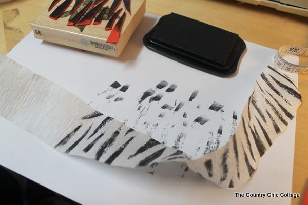 stamping white streamers on a desk