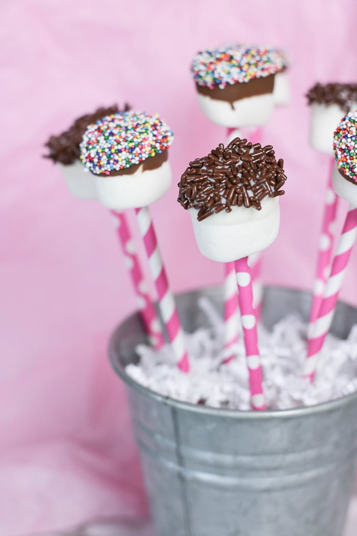 Chocolate dipped marshmallow straws coated with rainbow and chocolate sprinkles
