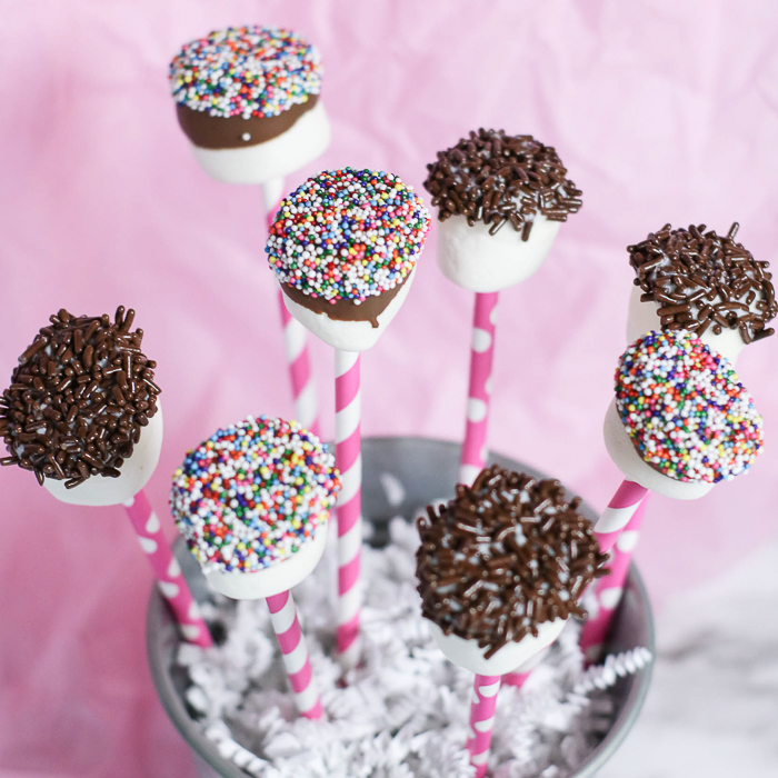 Chocolate covered marshmallow pops are a perfect bite-sized treat that you can dip in any kind of delicious topping you like