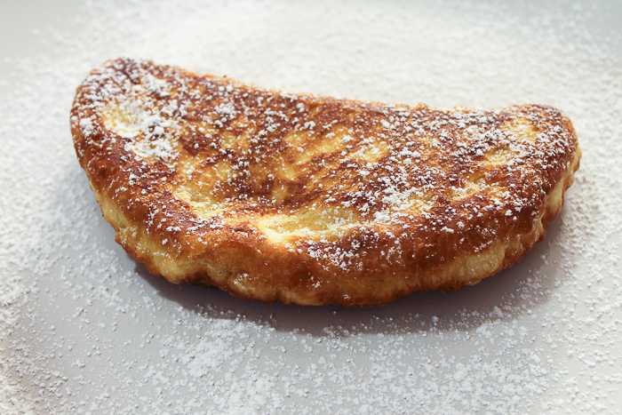 Fried pieces from canned biscuits dusted with powdered sugar.