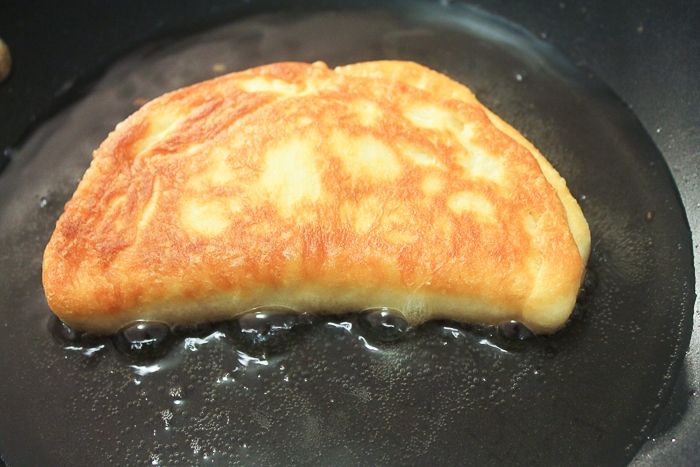 Frying Nutella fried pies in a skillet.