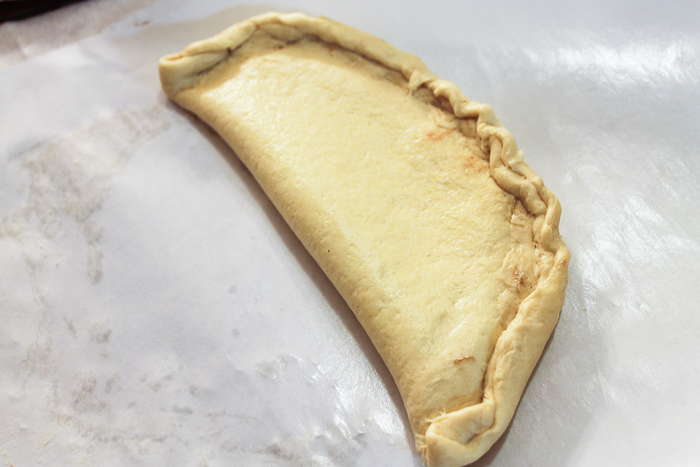 Folding over biscuit dough to make Nutella fried pies.