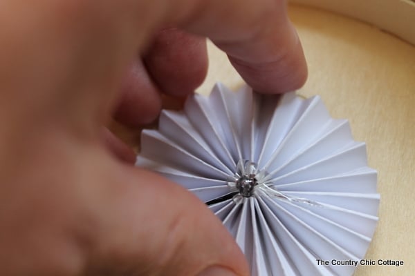 adding glue to paper pinwheel to keep its shape