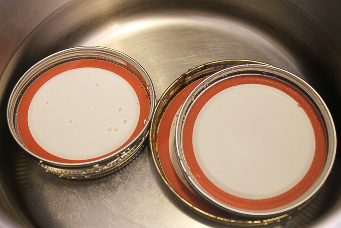 mason jar lids in simmering water