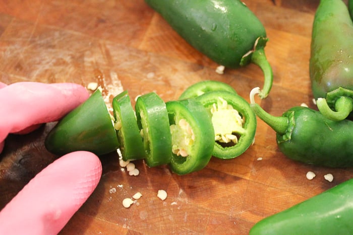 slicing jalapeno peppers with gloves