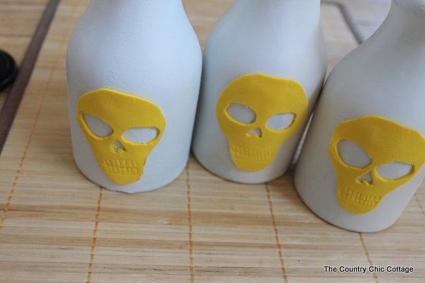 adding foam skull to milk bottles
