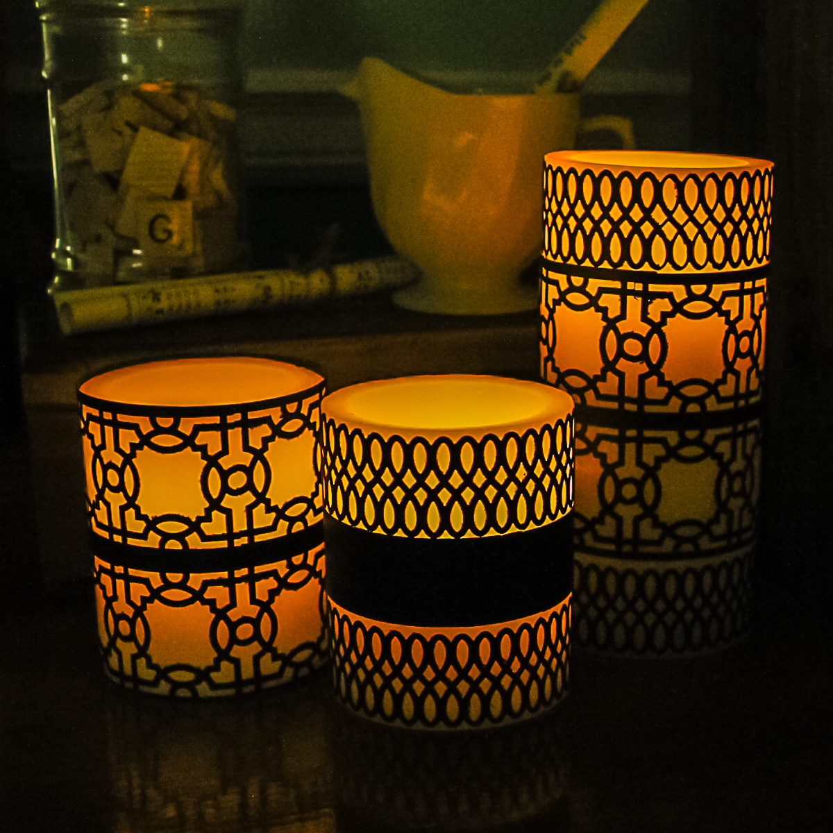 candles with punched paper wraps