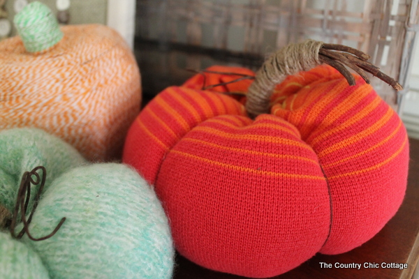 sweater pumpkins on wooden surface