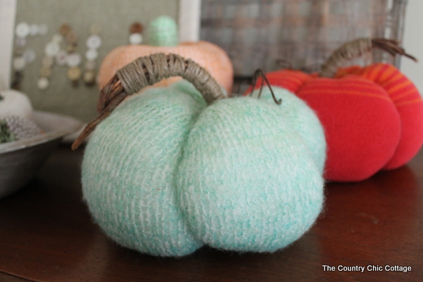 DIY Sweater Pumpkins one green pumpkin with orange in the background