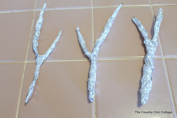 faux antler wreath from the pottery barn coat hanger antlers covered in foil