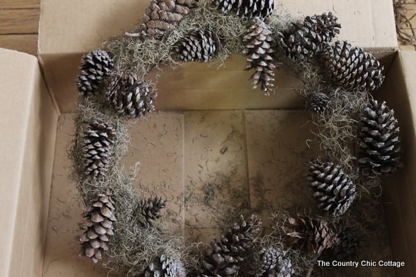 faux antler wreath from the pottery barn wire wreath form covered with moss and pine cones