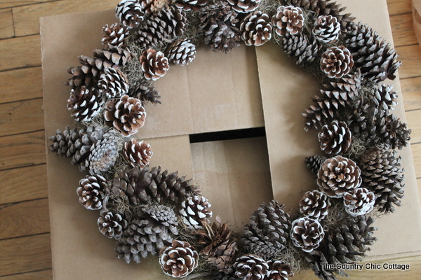faux antler wreath from the pottery barn painted pine cones added to wreath form