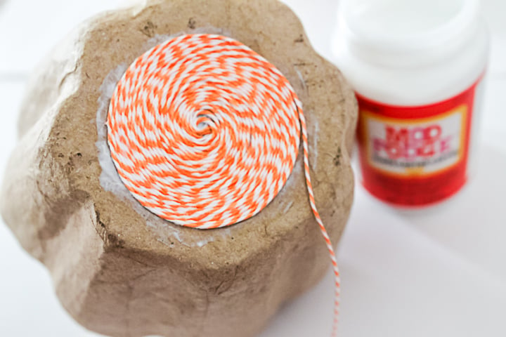 wrapping pumpkins with twine