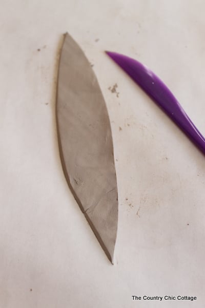 cutting clay into a feather shape