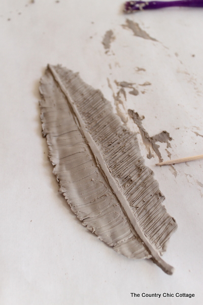adding details to clay feather