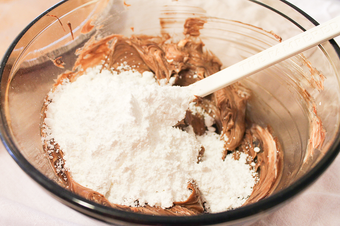 Adding powdered sugar to Nutella mixture