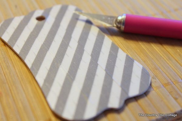 Trimming the edges of a gift tag with a craft knife