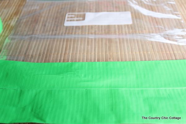 adding tape to plastic bag for diy checker board