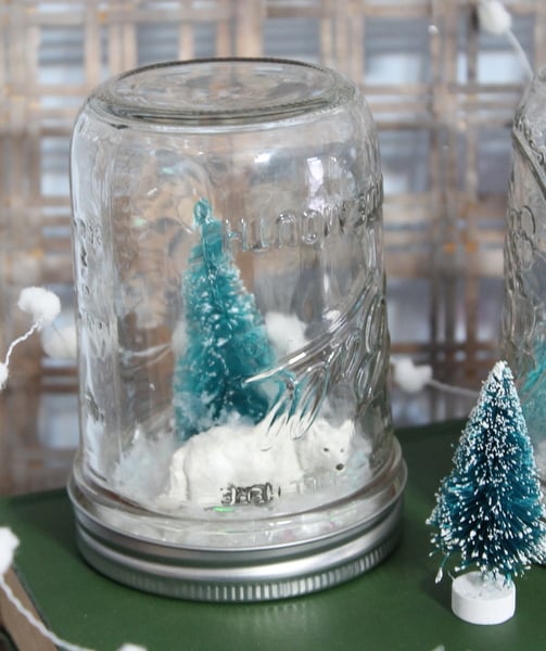 A Christmas tree and a polar bear inside of a mason jar. A DIY snow globe without water. 