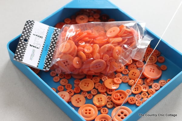 bin of orange buttons