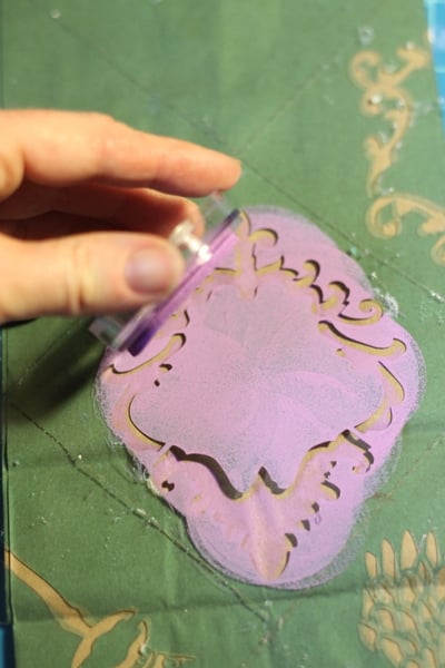 DIY Stenciled Wedding Favor Bags Applying ink to stencil on brown bag