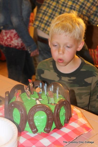 The birthday cowboy blowing out his birthday cake candles