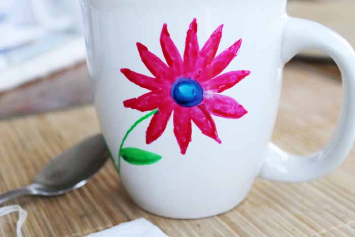 hand-painted mug with a flower on it