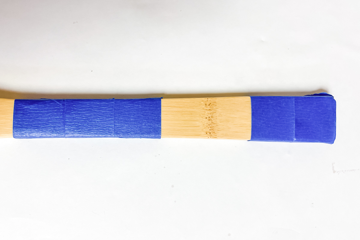 painter's tape on handle of wooden spoon