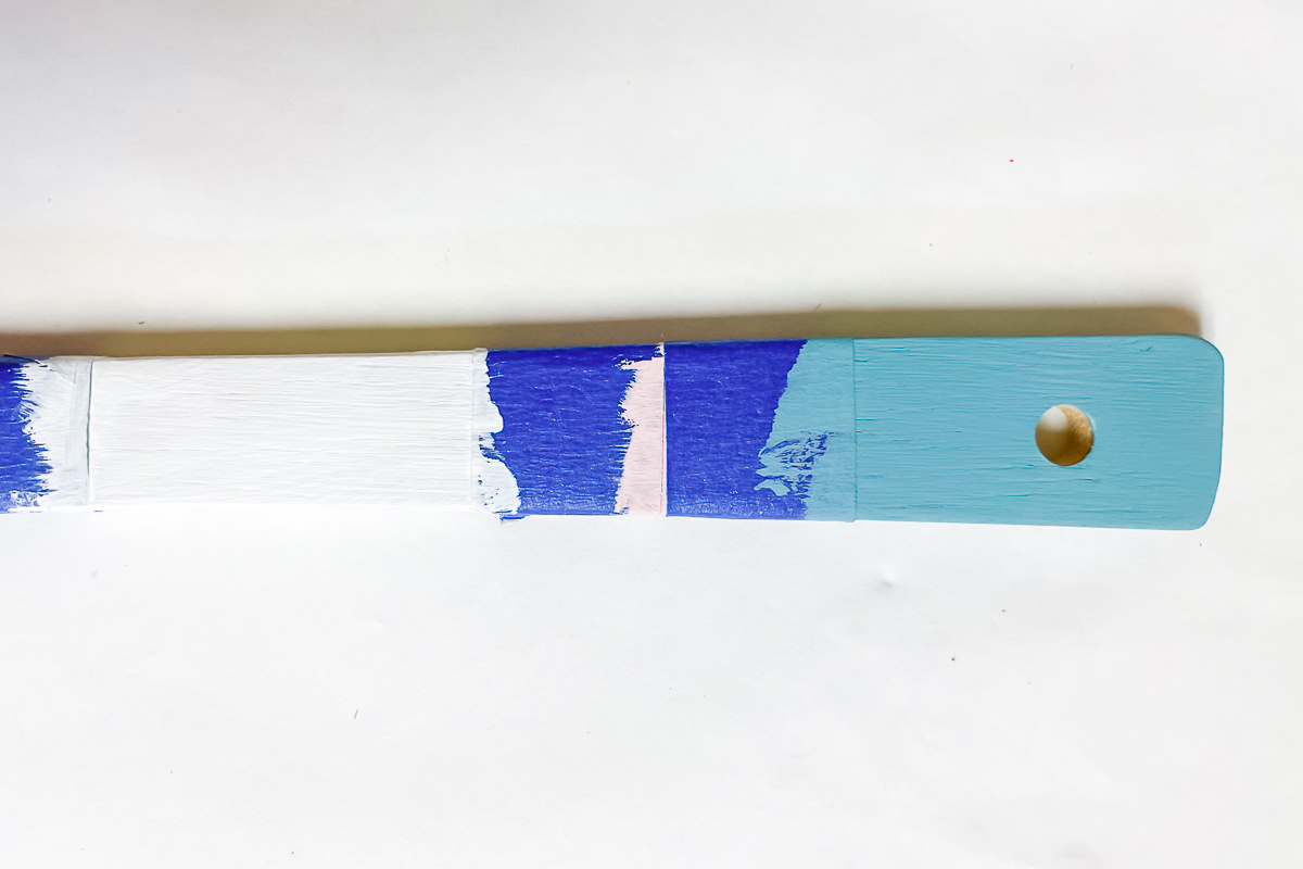 paint on wood spoon handle with masking tape