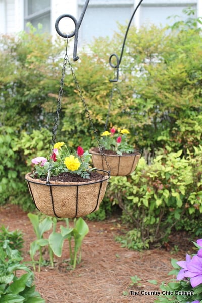 Turn old farm equipment into a way to hang your flowering baskets this summer! A great project for any yard. Plus enter to win a $25 gift card!