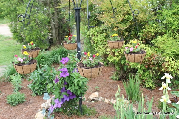 Turn old farm equipment into a way to hang your flowering baskets this summer! A great project for any yard. Plus enter to win a $25 gift card!