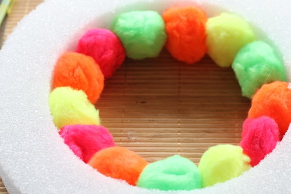 Neon Pompom Wreath -- make your front door shine this summer with a touch of these bright pompoms!