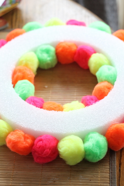Neon Pompom Wreath -- make your front door shine this summer with a touch of these bright pompoms!