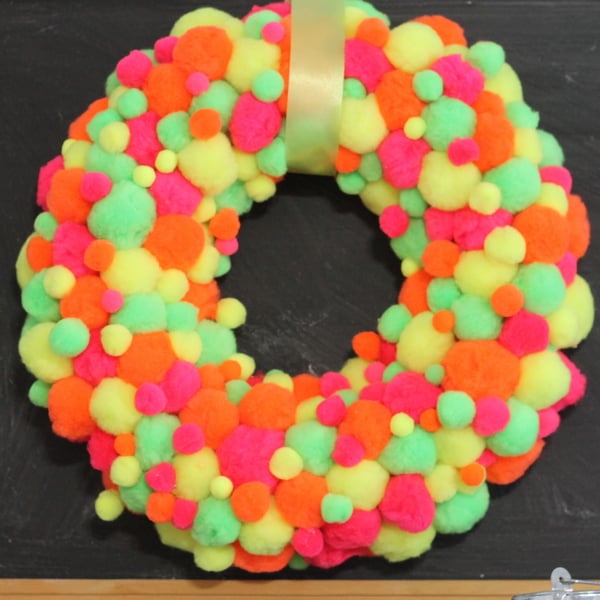 Neon Pompom Wreath -- make your front door shine this summer with a touch of these bright pompoms!