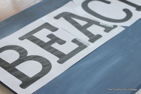 Ballard Designs Knock Off Beach Sign -- a great technique for getting a rusty appearance on a painted sign easily. You probably already have the secret ingredient in your kitchen! B-E-A-C-H letters laid out on sign