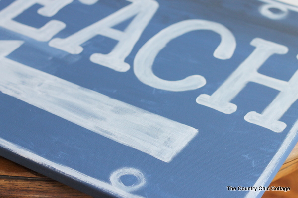 Ballard Designs Knock Off Beach Sign -- a great technique for getting a rusty appearance on a painted sign easily. You probably already have the secret ingredient in your kitchen! Ballard Designs Knock Off Beach Sign -closeup of paint