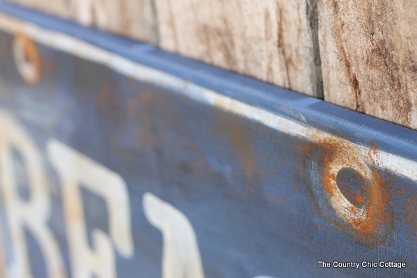 Ballard Designs Knock Off Beach Sign -- a great technique for getting a rusty appearance on a painted sign easily. You probably already have the secret ingredient in your kitchen! Ballard Designs Knock Off Beach Sign up close of "holes"