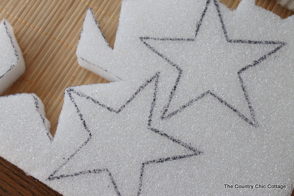 A great buttons and stars garland for your summer or 4th of July decor. Come see how to make this craft with Styrofoam, fabric, and buttons. star shapes marked on a piece of foam to cut out